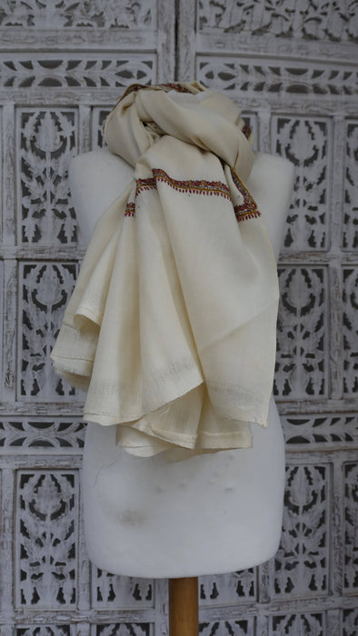 Cream wool shawl with orange, black and ochre corner motifs