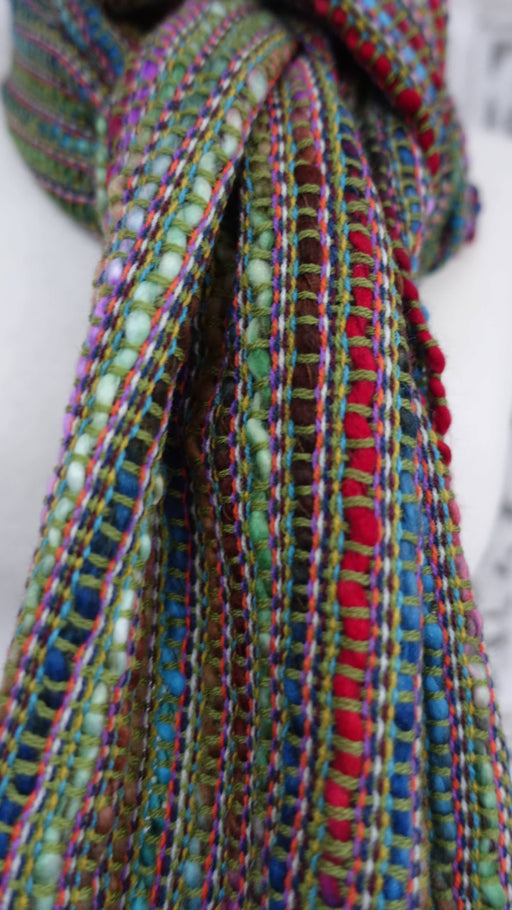 Earthy toned hands and looms woven colourful scarf – full length view
