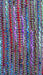 Earthy toned hands and looms woven colourful scarf – corner detail