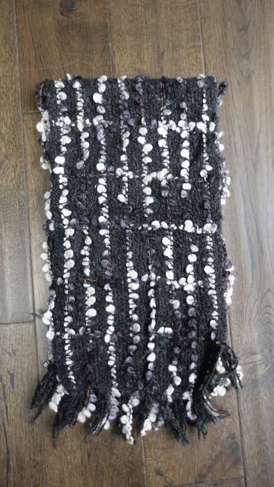 Black and white hands and looms winter scarf – close-up of the embellishment