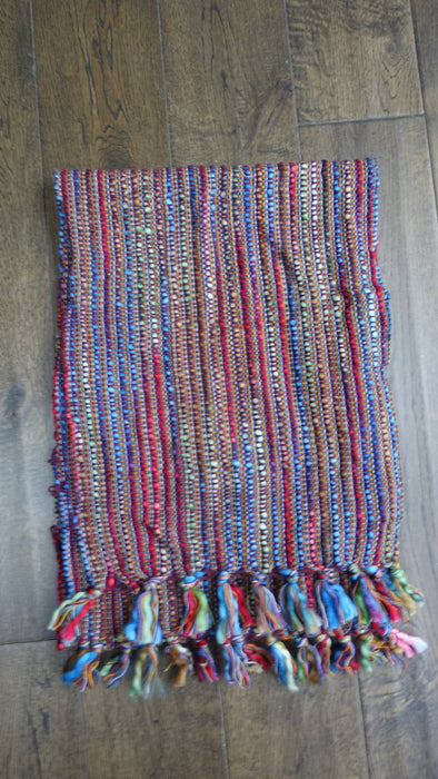 Colourful hands and looms colourful winter scarf – shown draped