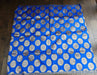 A royal blue fabric, It features a repeating pattern of large, metallic silver circular medallions with intricate gold and silver woven details.